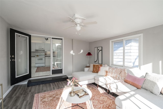 living room featuring hardwood / wood-style floors and ceiling fan