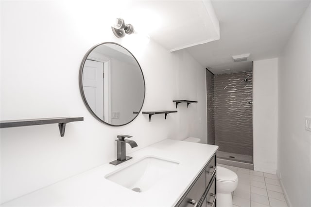 bathroom featuring tiled shower, vanity, toilet, and tile patterned flooring