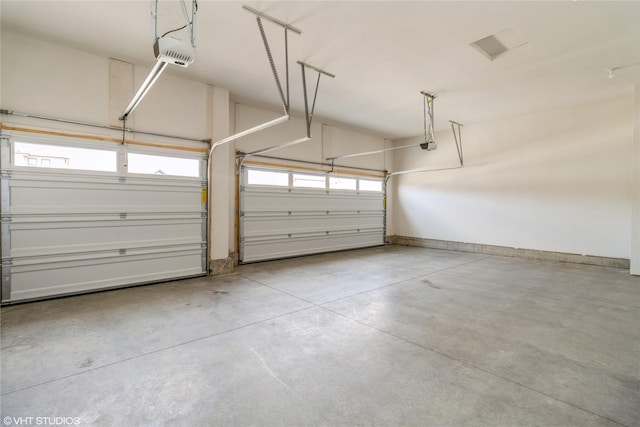 300 NW Ashley Ave, Waukee, IA 50263 - garage featuring baseboards and a garage door opener