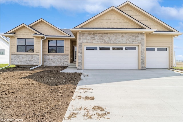 300 NW Ashley Ave, Waukee, IA 50263 - craftsman-style house featuring an attached garage, stone siding, and concrete driveway
