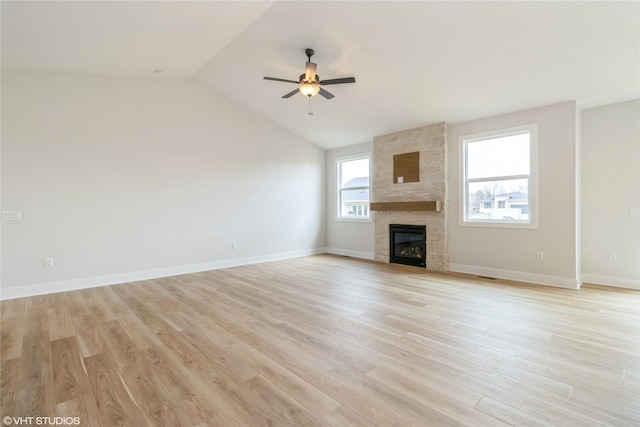 300 NW Ashley Ave, Waukee, IA 50263 - unfurnished living room with a large fireplace, ceiling fan, vaulted ceiling, and light wood-style floors