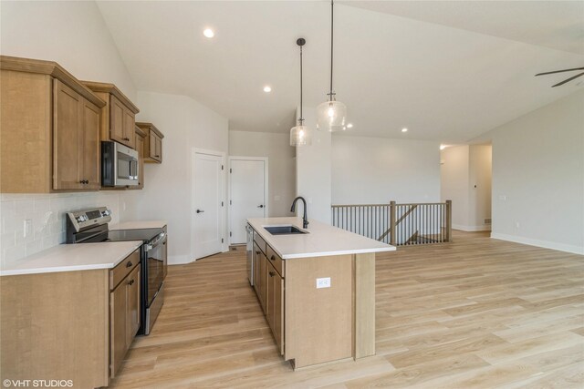 300 NW Ashley Ave, Waukee, IA 50263 - kitchen featuring tasteful backsplash, light wood-style floors, brown cabinets, stainless steel appliances, and a sink
