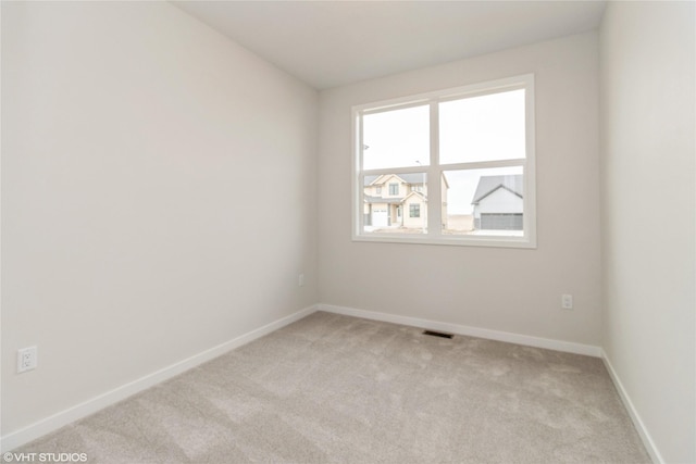 300 NW Ashley Ave, Waukee, IA 50263 - empty room featuring light carpet, baseboards, and visible vents