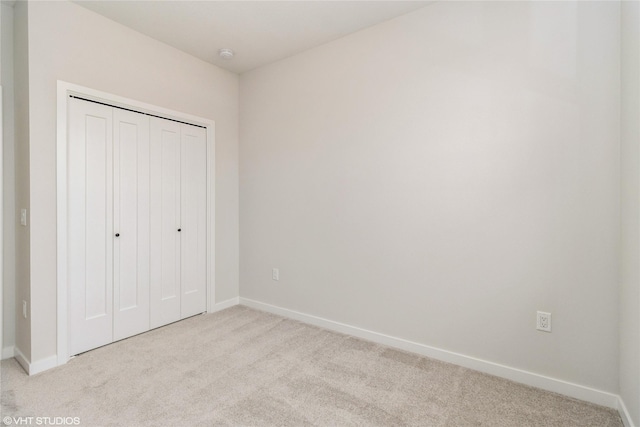 300 NW Ashley Ave, Waukee, IA 50263 - unfurnished bedroom featuring a closet, baseboards, and carpet floors