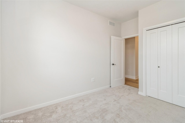 300 NW Ashley Ave, Waukee, IA 50263 - unfurnished bedroom featuring carpet floors, baseboards, a closet, and visible vents