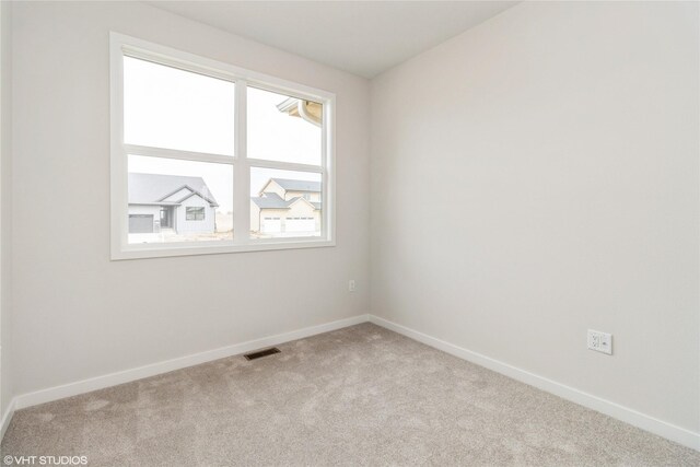 300 NW Ashley Ave, Waukee, IA 50263 - unfurnished room featuring visible vents, baseboards, and carpet