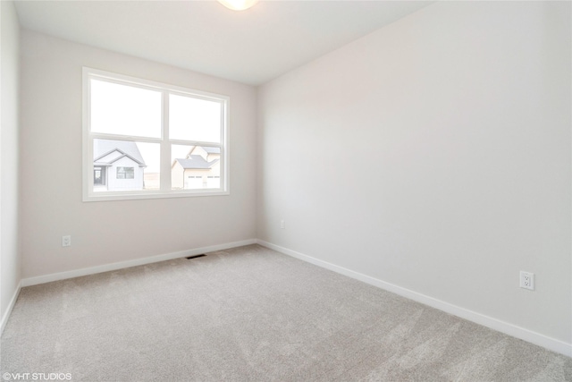 300 NW Ashley Ave, Waukee, IA 50263 - carpeted empty room featuring visible vents and baseboards