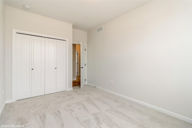 300 NW Ashley Ave, Waukee, IA 50263 - unfurnished bedroom featuring a closet, carpet flooring, visible vents, and baseboards