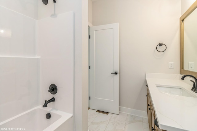 300 NW Ashley Ave, Waukee, IA 50263 - full bath featuring marble finish floor, baseboards, washtub / shower combination, and vanity