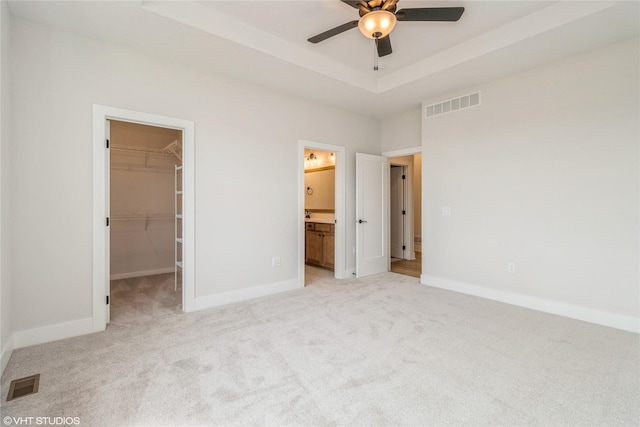 300 NW Ashley Ave, Waukee, IA 50263 - unfurnished bedroom featuring light colored carpet, baseboards, a spacious closet, and visible vents