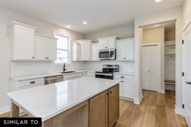 kitchen featuring sink, white cabinetry, and appliances with stainless steel finishes