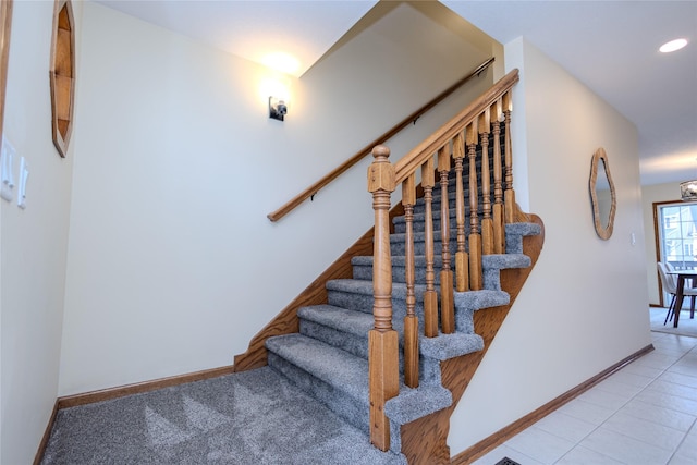 stairway with recessed lighting, baseboards, and tile patterned floors