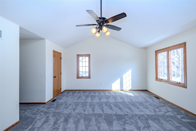 carpeted spare room featuring visible vents, vaulted ceiling, and baseboards