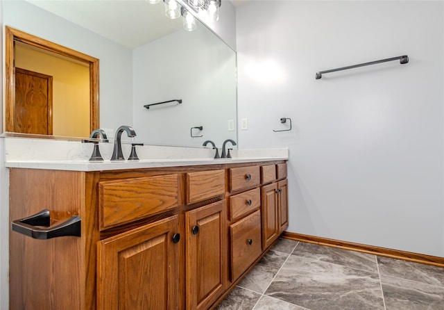 bathroom featuring double vanity, a sink, and baseboards