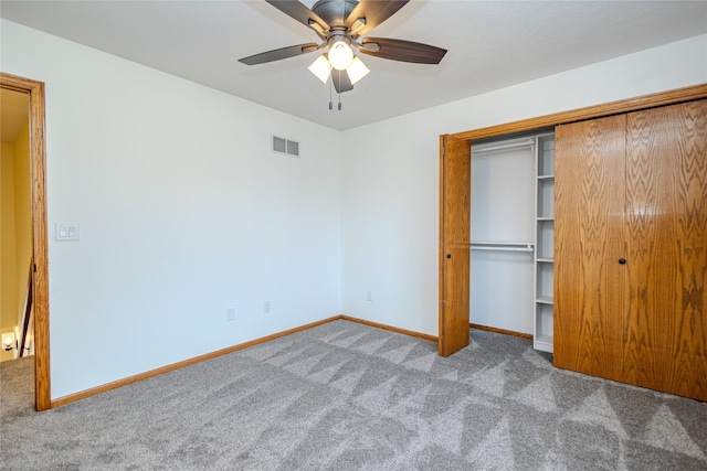 unfurnished bedroom with carpet floors, a closet, visible vents, and baseboards