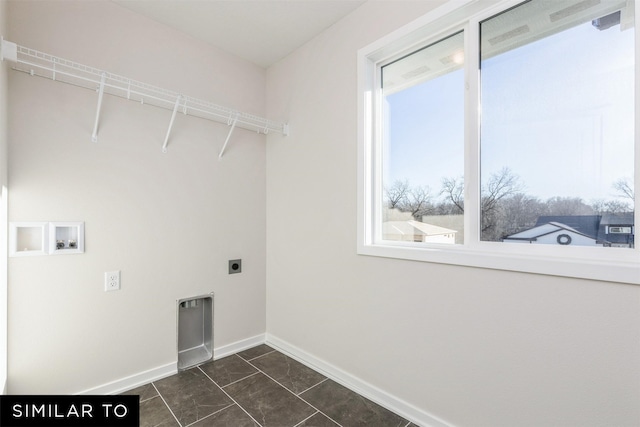 washroom featuring dark tile patterned flooring, hookup for an electric dryer, hookup for a washing machine, and a wealth of natural light