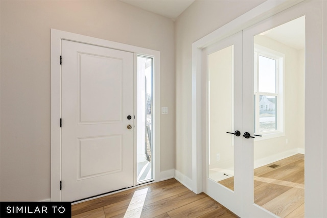 entryway featuring french doors and light hardwood / wood-style floors