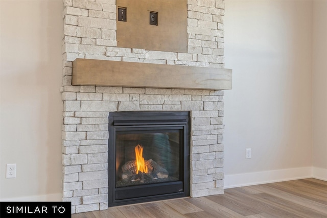 room details with a fireplace and wood-type flooring