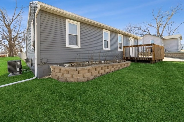 rear view of property with a wooden deck, a yard, and central air condition unit