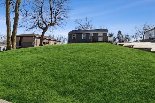 view of front of home featuring a wooden deck and a front yard