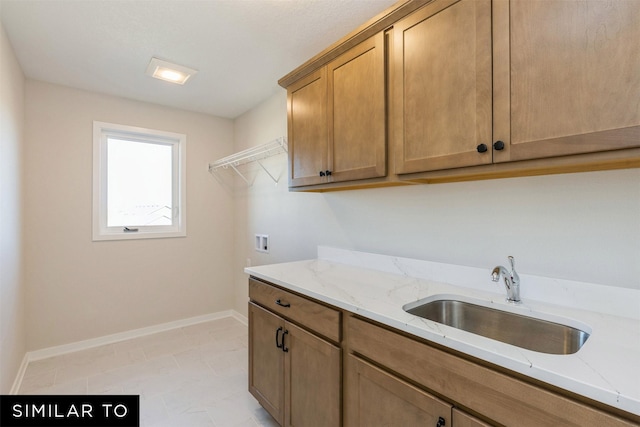 laundry area with sink, cabinets, and washer hookup