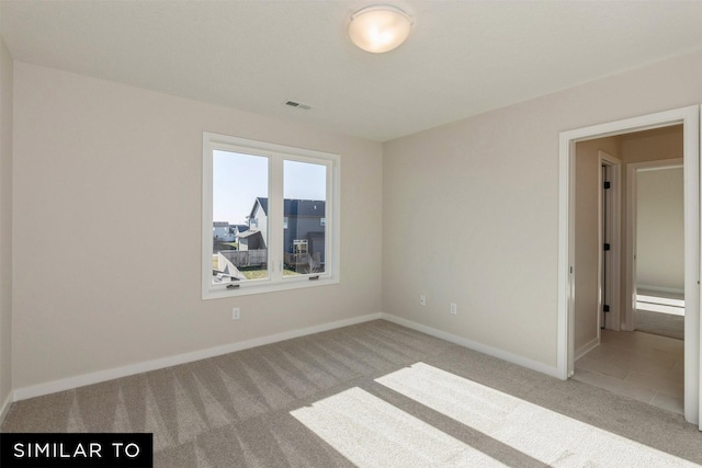 empty room with light colored carpet