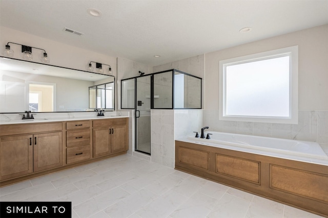 bathroom with independent shower and bath, tile patterned floors, and vanity