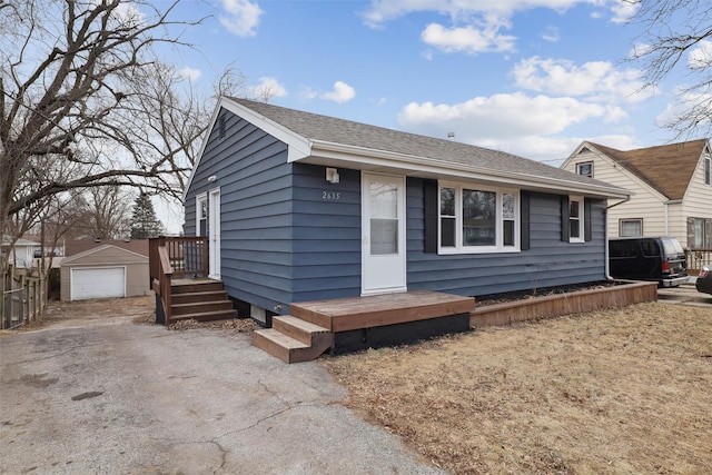 view of front of property featuring a garage and an outdoor structure