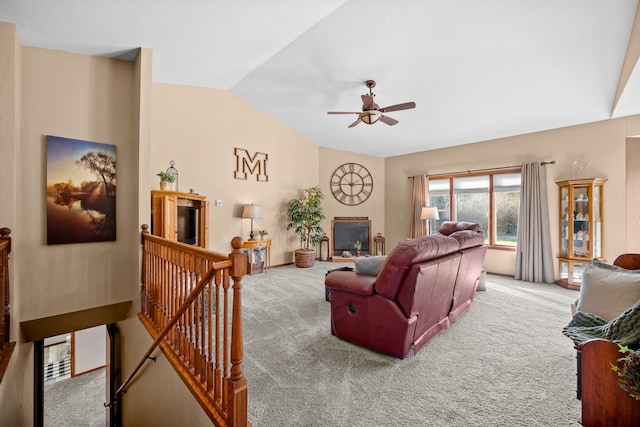 carpeted living room featuring ceiling fan and lofted ceiling