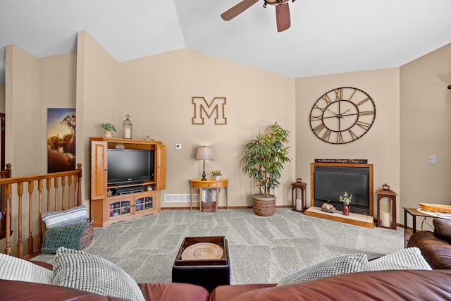 carpeted living room featuring ceiling fan and lofted ceiling