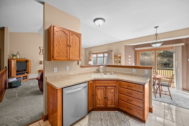 kitchen featuring dishwasher, light carpet, sink, hanging light fixtures, and kitchen peninsula