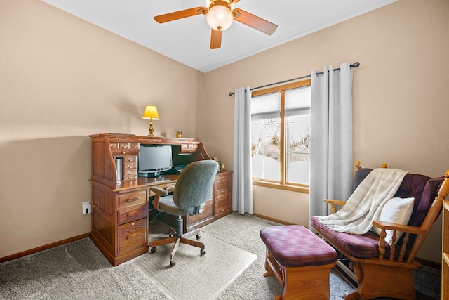 carpeted home office featuring ceiling fan