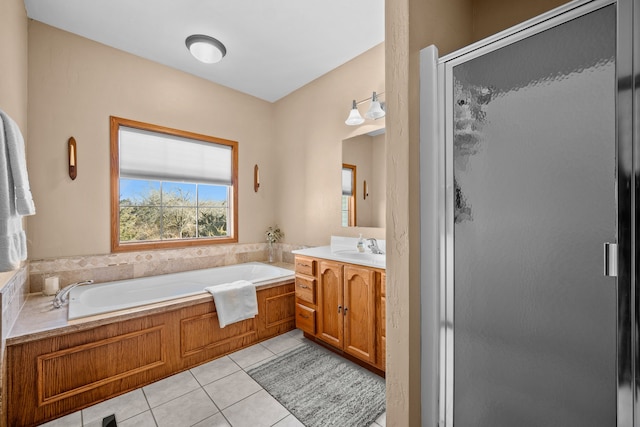 bathroom featuring plus walk in shower, tile patterned flooring, and vanity