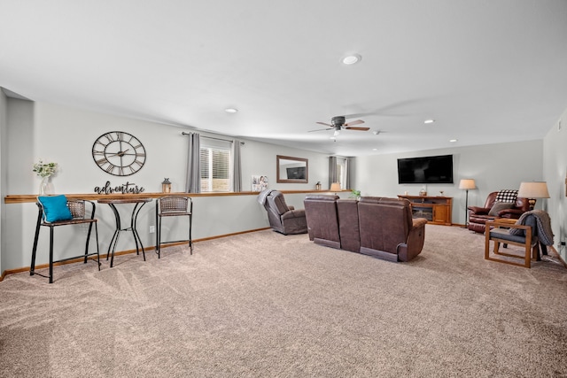 carpeted living room featuring ceiling fan