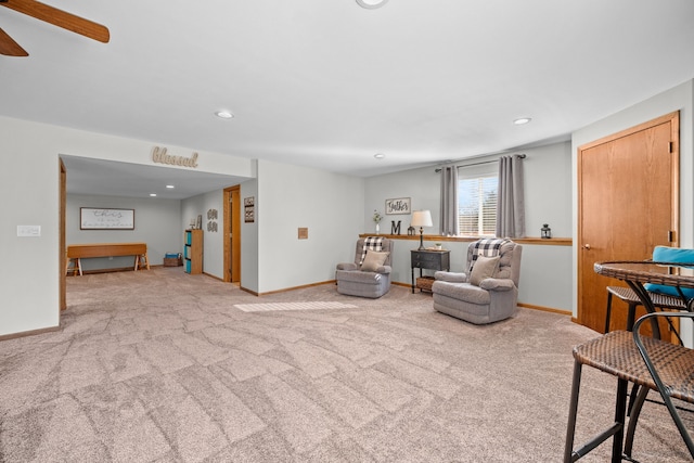 carpeted living room with ceiling fan