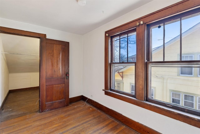 unfurnished bedroom with dark hardwood / wood-style flooring