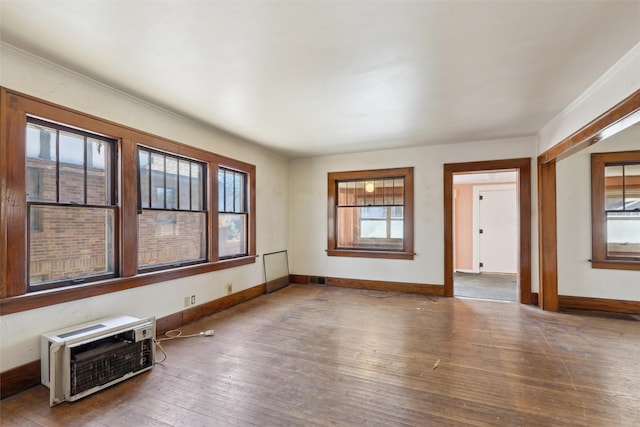 empty room featuring hardwood / wood-style flooring and heating unit