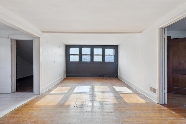 unfurnished room featuring hardwood / wood-style flooring