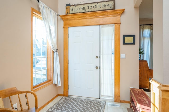 tiled foyer entrance with a wealth of natural light