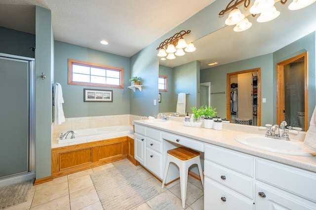 bathroom with independent shower and bath, tile patterned floors, and vanity