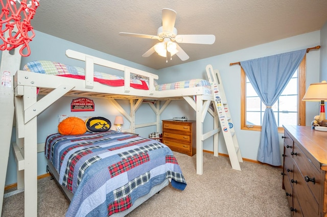 bedroom featuring ceiling fan, carpet, and a textured ceiling