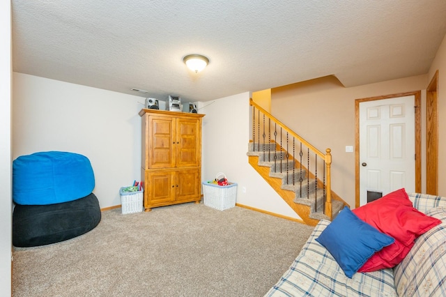 interior space featuring carpet flooring and a textured ceiling