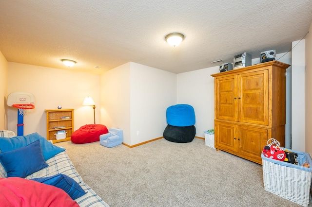 recreation room featuring carpet and a textured ceiling