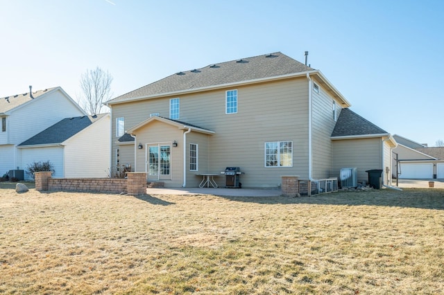 rear view of house featuring central air condition unit, a patio area, and a lawn