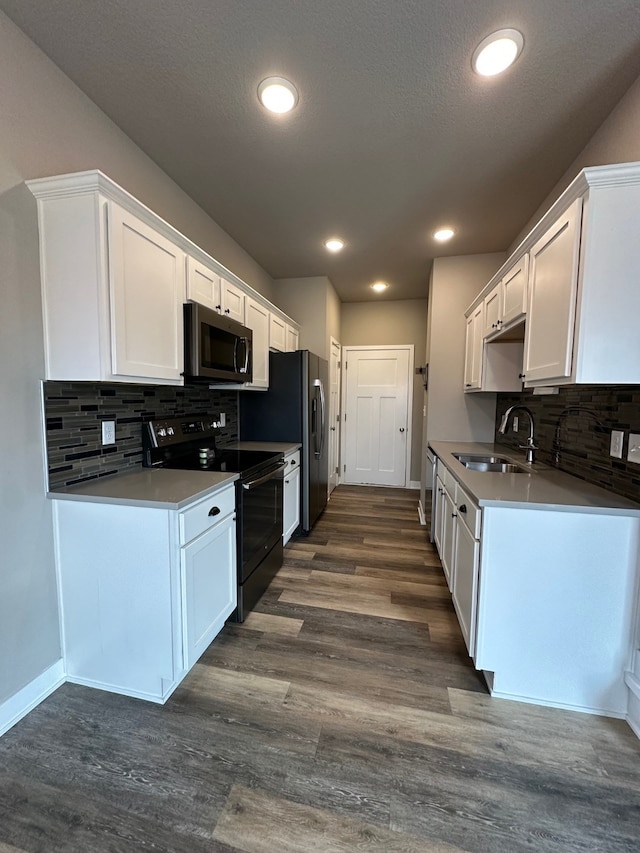 kitchen featuring white cabinetry, decorative backsplash, sink, dark hardwood / wood-style floors, and electric range