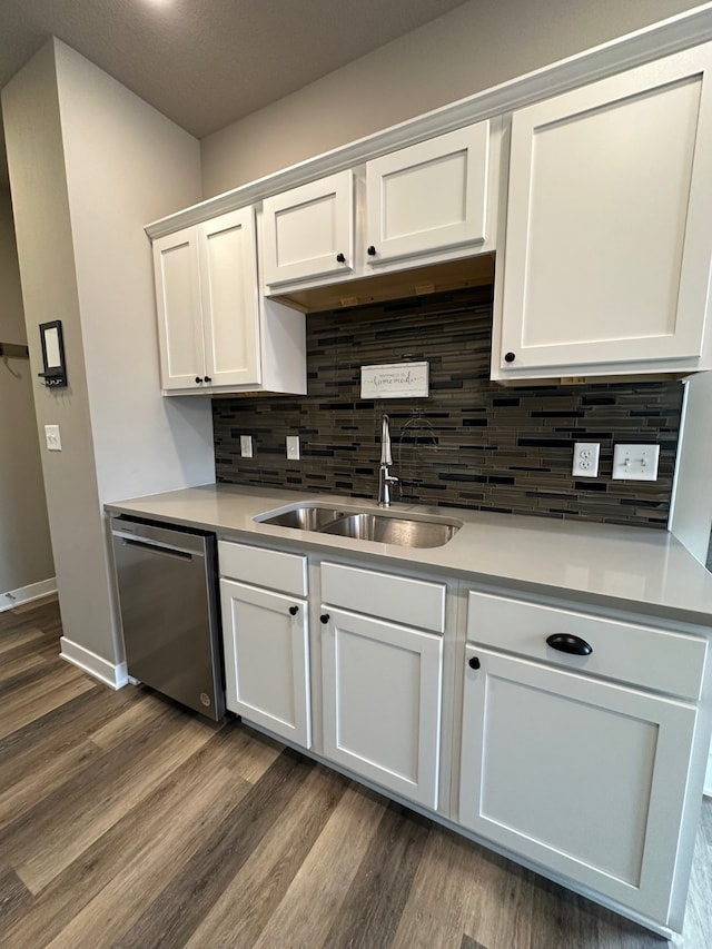 kitchen featuring sink, stainless steel dishwasher, dark hardwood / wood-style floors, and white cabinets