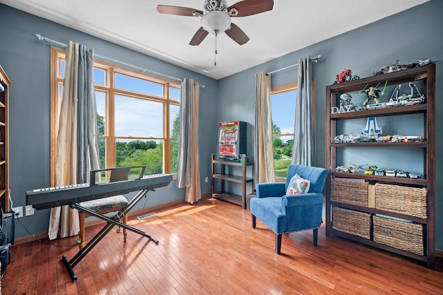 home office with ceiling fan, wood-type flooring, and a wealth of natural light