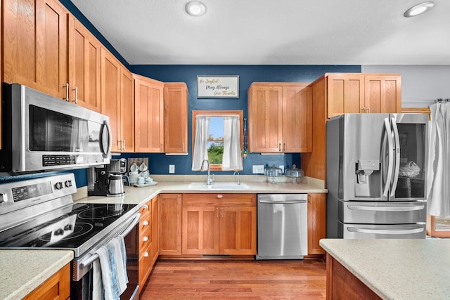 kitchen featuring light hardwood / wood-style floors, sink, and stainless steel appliances