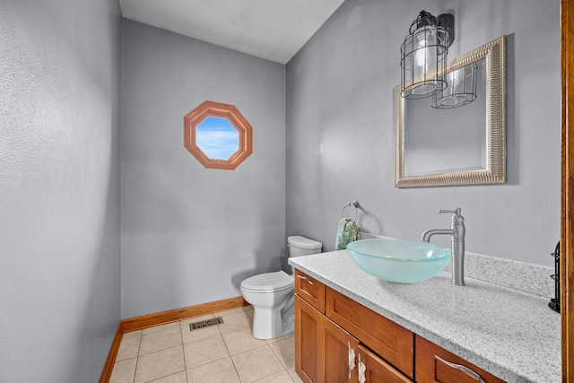 bathroom featuring toilet, tile patterned floors, and vanity