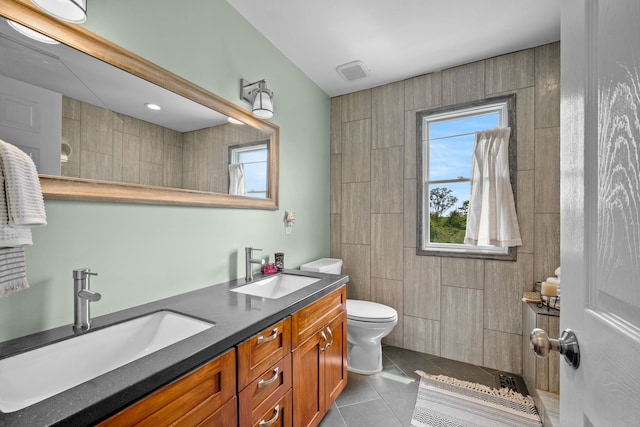 bathroom featuring toilet, vanity, and tile patterned flooring